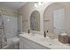 Bathroom featuring double sinks with elegant fixtures, framed mirrors, and a bathtub with shower at 7710 Epping Forest Dr, Huntersville, NC 28078