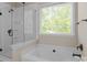 Modern bathroom with a glass-enclosed shower and separate tub at 7710 Epping Forest Dr, Huntersville, NC 28078
