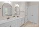 Bathroom featuring dual sinks, granite countertops, and modern fixtures at 7710 Epping Forest Dr, Huntersville, NC 28078