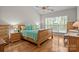 Sunny bedroom with wood floors, a ceiling fan, and natural light from large windows at 7710 Epping Forest Dr, Huntersville, NC 28078