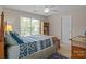 Bright bedroom with large window, ceiling fan, bookshelf, and a comfortable bed at 7710 Epping Forest Dr, Huntersville, NC 28078