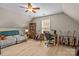 Spacious bonus room with a comfortable sofa, ceiling fan, and desk for a cozy retreat at 7710 Epping Forest Dr, Huntersville, NC 28078