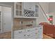 Elegant dining area featuring custom cabinets, granite countertops, and a wine rack at 7710 Epping Forest Dr, Huntersville, NC 28078