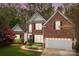 Charming two-story red brick home with manicured lawn and attached two car garage at 7710 Epping Forest Dr, Huntersville, NC 28078