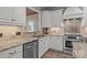 Close-up of a kitchen with stainless steel appliances and light granite countertops at 7710 Epping Forest Dr, Huntersville, NC 28078