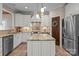 Well-equipped kitchen with white cabinets, an island, stainless steel appliances, and granite countertops at 7710 Epping Forest Dr, Huntersville, NC 28078