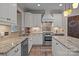 Modern kitchen featuring granite countertops, stainless steel appliances, and white cabinets at 7710 Epping Forest Dr, Huntersville, NC 28078