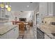 Open concept kitchen featuring granite countertops, custom cabinets, and easy access to the living area at 7710 Epping Forest Dr, Huntersville, NC 28078