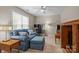 Inviting living room with comfortable seating, two desks, and bright, natural light from the windows at 7710 Epping Forest Dr, Huntersville, NC 28078
