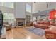 Open living room with a fireplace, hardwood floors, and large windows at 7710 Epping Forest Dr, Huntersville, NC 28078
