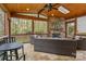Inviting screened-in porch with a stone fireplace, wood ceiling, and comfortable seating at 7710 Epping Forest Dr, Huntersville, NC 28078
