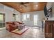 Spacious sunroom with wood ceiling, comfortable seating, and outdoor access at 7710 Epping Forest Dr, Huntersville, NC 28078