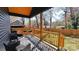Inviting back porch with outdoor seating, wooden railing, and a grill, perfect for relaxing or entertaining guests at 782 Chalice Sw St, Concord, NC 28027