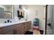 Modern bathroom with double sinks, wood cabinets, and luxurious black hardware at 782 Chalice Sw St, Concord, NC 28027