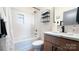 Stylish bathroom with white subway tile, wood vanity, tub, and shower with glass enclosure, and sleek fixtures at 782 Chalice Sw St, Concord, NC 28027