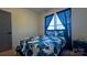 Charming bedroom features a floral patterned bedspread, modern flooring, and natural light from a window at 782 Chalice Sw St, Concord, NC 28027