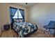 Cozy bedroom features a floral patterned bedspread, modern flooring, and natural light from a window at 782 Chalice Sw St, Concord, NC 28027