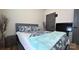 Comfortable bedroom showcasing a gray bed, wood-look floors, and a flat screen television at 782 Chalice Sw St, Concord, NC 28027