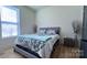 Cozy bedroom featuring a comfortable bed with stylish bedding and a light-filled window at 782 Chalice Sw St, Concord, NC 28027