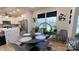 Bright dining area features a round table, gray chairs, and abundant natural light from a window with black accents at 782 Chalice Sw St, Concord, NC 28027
