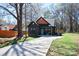 Exterior shot of a home with a light blue door, well-manicured lawn, and long driveway at 782 Chalice Sw St, Concord, NC 28027