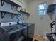 Well-equipped laundry room with modern washer and dryer, shelving for storage, and efficient layout at 782 Chalice Sw St, Concord, NC 28027