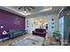 Bright living space with purple accent wall, open to the kitchen, featuring stylish furniture and decor at 782 Chalice Sw St, Concord, NC 28027