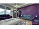 Chic living room featuring vibrant purple accent wall, stylish furniture, and decor at 782 Chalice Sw St, Concord, NC 28027