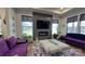 Contemporary living room with a sleek fireplace, large windows, and stylish purple sofas at 782 Chalice Sw St, Concord, NC 28027