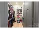 Organized walk-in closet with shelving units and ample storage space for clothing and accessories at 782 Chalice Sw St, Concord, NC 28027