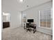 Bedroom with a work space next to an en suite bath and bright windows at 9582 Creighton Nw Rd, Concord, NC 28027