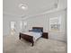 Spacious bedroom with carpeting, tray ceiling, and ensuite bath access at 9582 Creighton Nw Rd, Concord, NC 28027