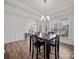 Bright dining room with elegant lighting, wood floors, and views of the living area at 9582 Creighton Nw Rd, Concord, NC 28027