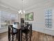 Stylish dining area boasting natural light, wood floors, and elegant finishes throughout the space at 9582 Creighton Nw Rd, Concord, NC 28027