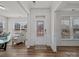Inviting entryway with wood floors, a decorative front door, and a view into the bright living space at 9582 Creighton Nw Rd, Concord, NC 28027