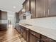 Well-appointed kitchen with granite countertops, dark wood cabinets, and a gas cooktop stove at 9582 Creighton Nw Rd, Concord, NC 28027