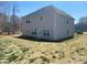 Backyard view of a two-story home with vinyl siding and a large grass lawn at 104 Mulligan Dr, Shelby, NC 28150