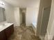 Bright bathroom featuring double sinks, dark wood cabinets, and a separate shower-tub for comfort at 104 Mulligan Dr, Shelby, NC 28150
