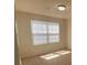 A bright bedroom features neutral carpet, window with blinds, and a ceiling light at 104 Mulligan Dr, Shelby, NC 28150