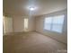 Bright, carpeted room with a large window, neutral walls and trim providing ample natural light at 104 Mulligan Dr, Shelby, NC 28150