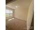 Cozy bedroom with neutral walls, soft carpet flooring, and plenty of natural light from the large windows at 104 Mulligan Dr, Shelby, NC 28150