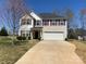 Charming two-story home with a neutral color palette, manicured lawn, and a spacious two-car garage at 104 Mulligan Dr, Shelby, NC 28150