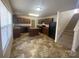 Functional kitchen with a center island, dark cabinetry, modern appliances, and adjacent staircase at 104 Mulligan Dr, Shelby, NC 28150