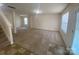 Spacious living room featuring neutral walls, plush carpet, and ample natural light streaming through the window at 104 Mulligan Dr, Shelby, NC 28150