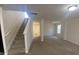 Bright living area boasting a staircase, neutral walls, carpet flooring, and a well-lit ambiance at 104 Mulligan Dr, Shelby, NC 28150