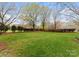 Spacious backyard featuring a well-maintained lawn, mature trees, and neatly trimmed shrubbery at 10809 Wicklow Brook Ct, Charlotte, NC 28277