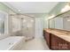 Bathroom featuring a glass enclosed shower, soaking tub, and double sink vanity at 10809 Wicklow Brook Ct, Charlotte, NC 28277