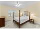 Bedroom with a four poster bed, cream walls, and plenty of natural light at 10809 Wicklow Brook Ct, Charlotte, NC 28277