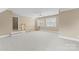 Spacious bonus room featuring neutral carpeting, staircase access, and bright natural light from multiple windows at 10809 Wicklow Brook Ct, Charlotte, NC 28277