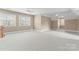Expansive bonus room with neutral carpet, multiple windows, and ceiling fans for a comfortable, versatile space at 10809 Wicklow Brook Ct, Charlotte, NC 28277